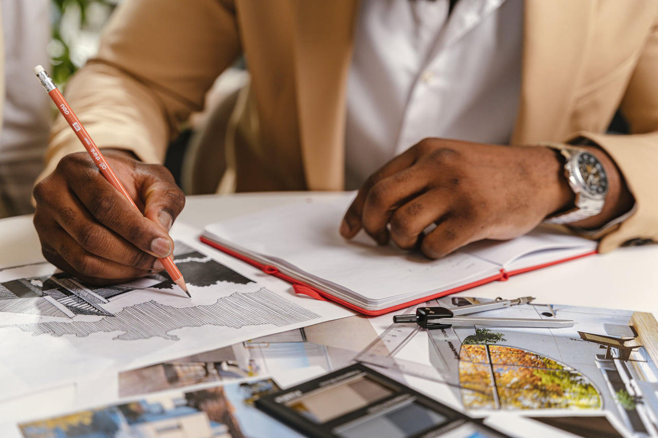 A man working on an home exterior concept sketch.